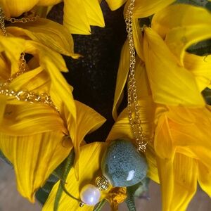 Green speckled glass heart & fresh water pearl on a 20 inch gold plated necklace